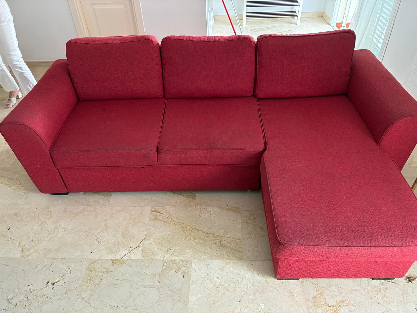 Red sofa before professional upholstery cleaning by Clean Sur