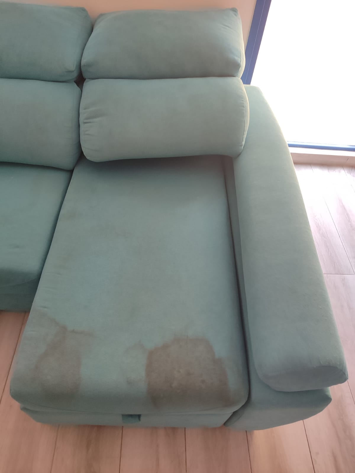 Turquoise lounge sofa before professional upholstery cleaning by Clean Sur