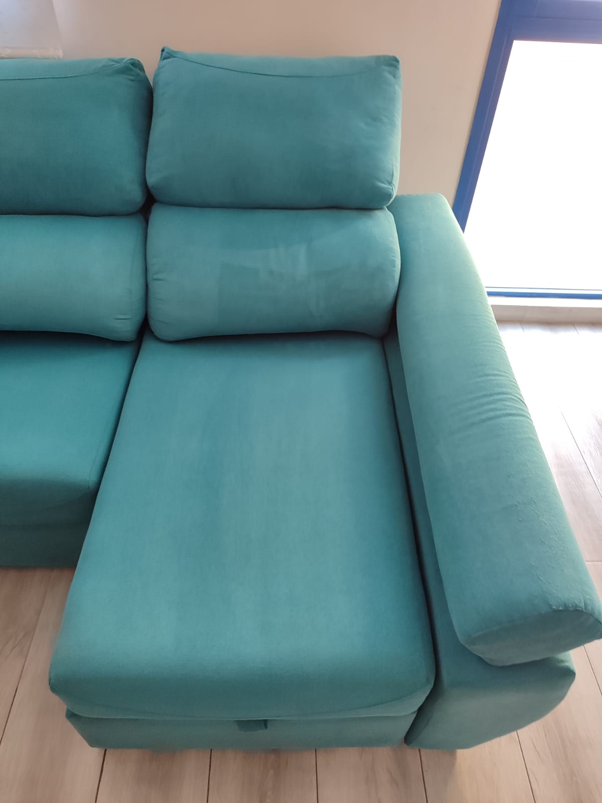 Turquoise lounge sofa after professional upholstery cleaning by Clean Sur